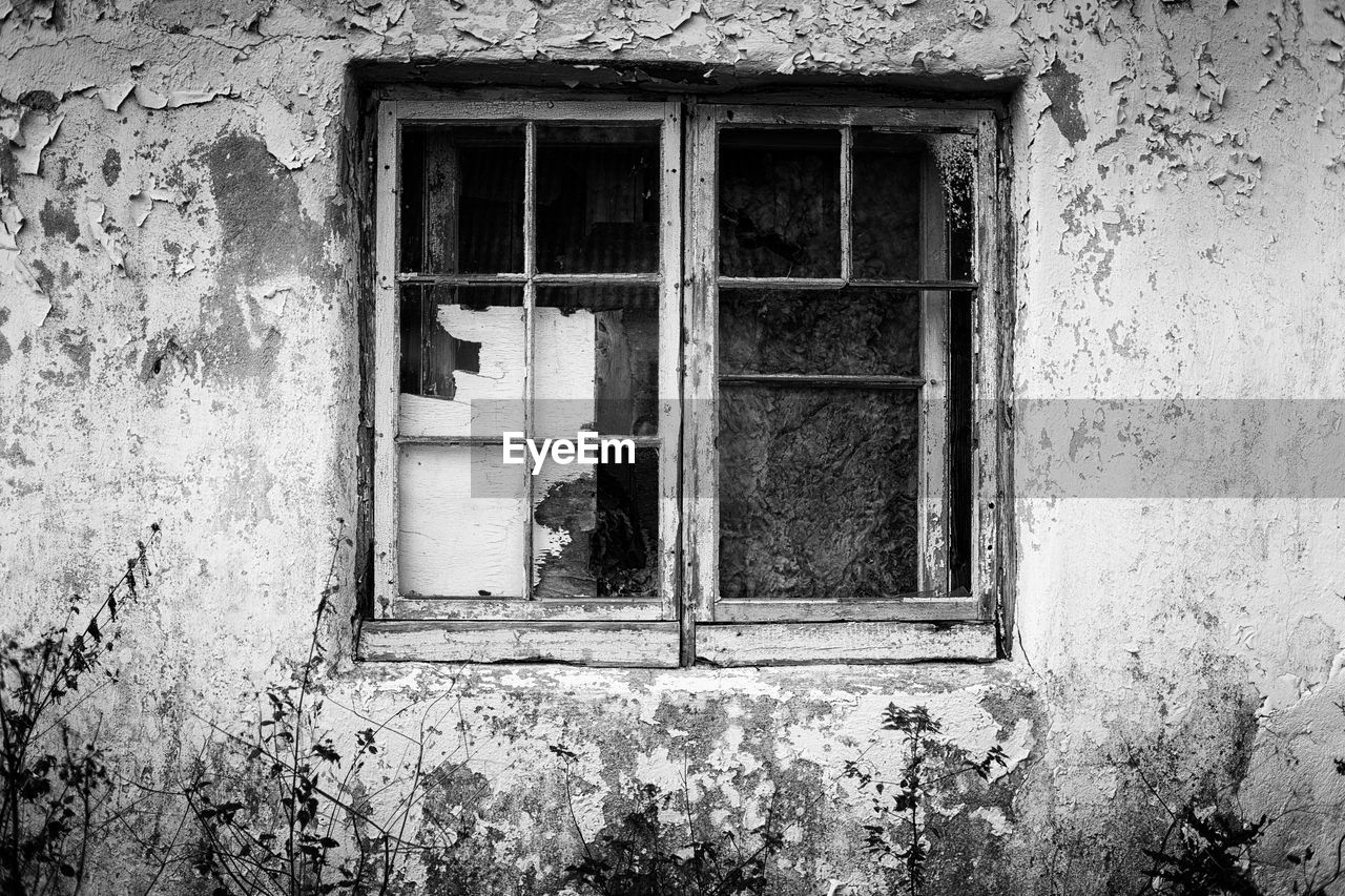 Closed window of abandoned house
