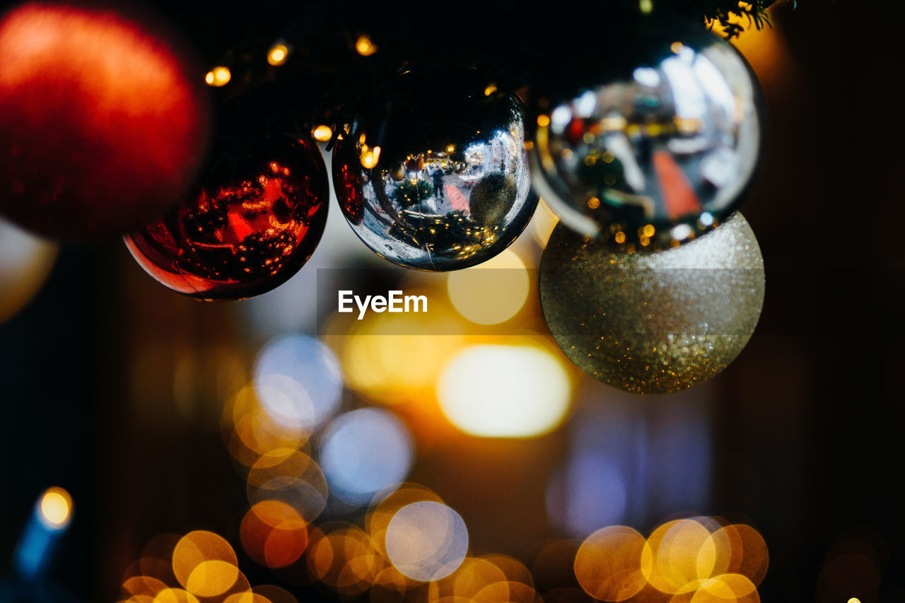 Close-up of ornaments hanging on christmas tree