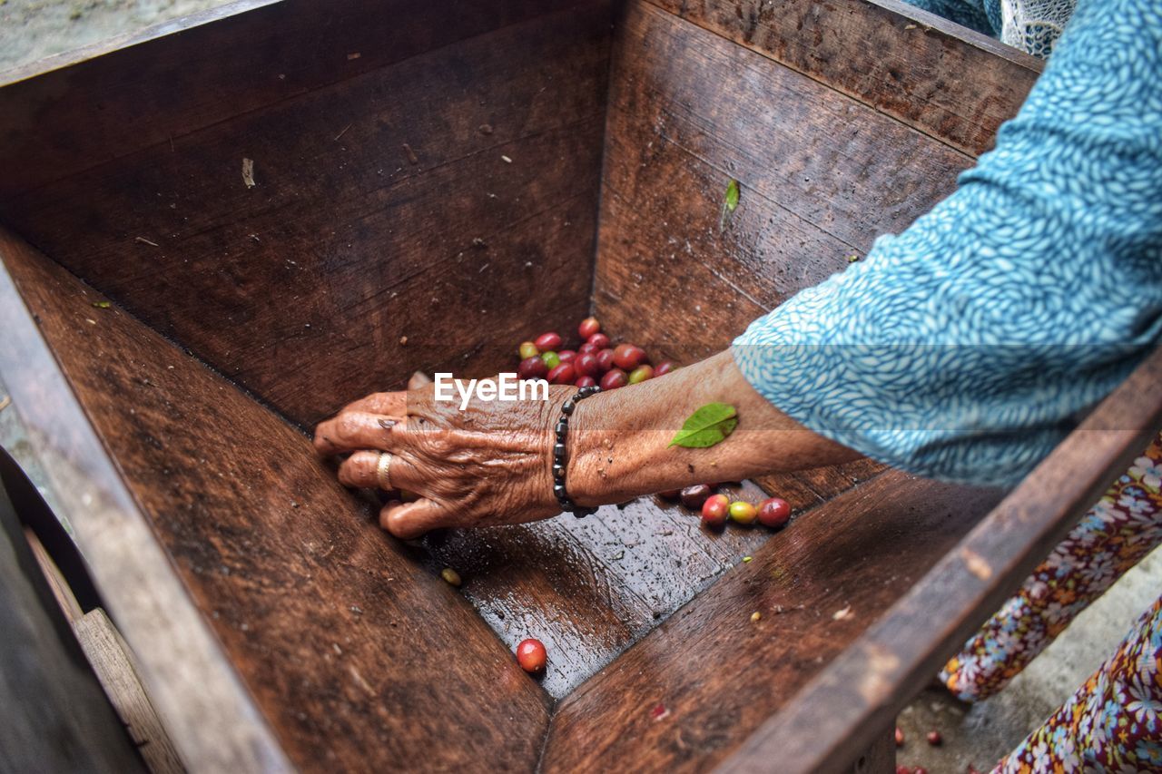 HIGH ANGLE VIEW OF MAN WORKING ON WOODEN FLOOR