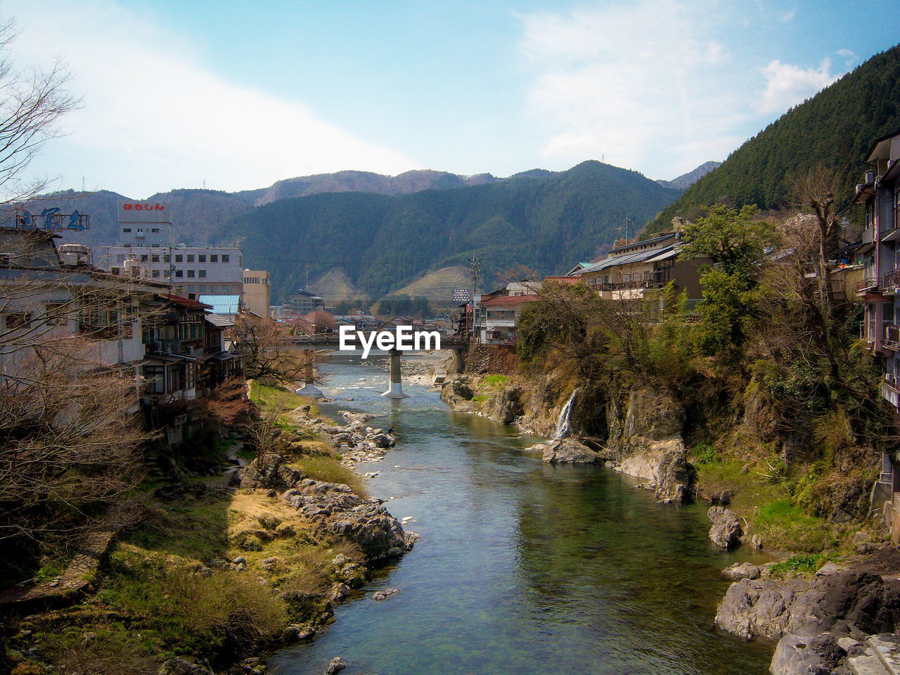 VIEW OF RIVER WITH TOWN IN BACKGROUND