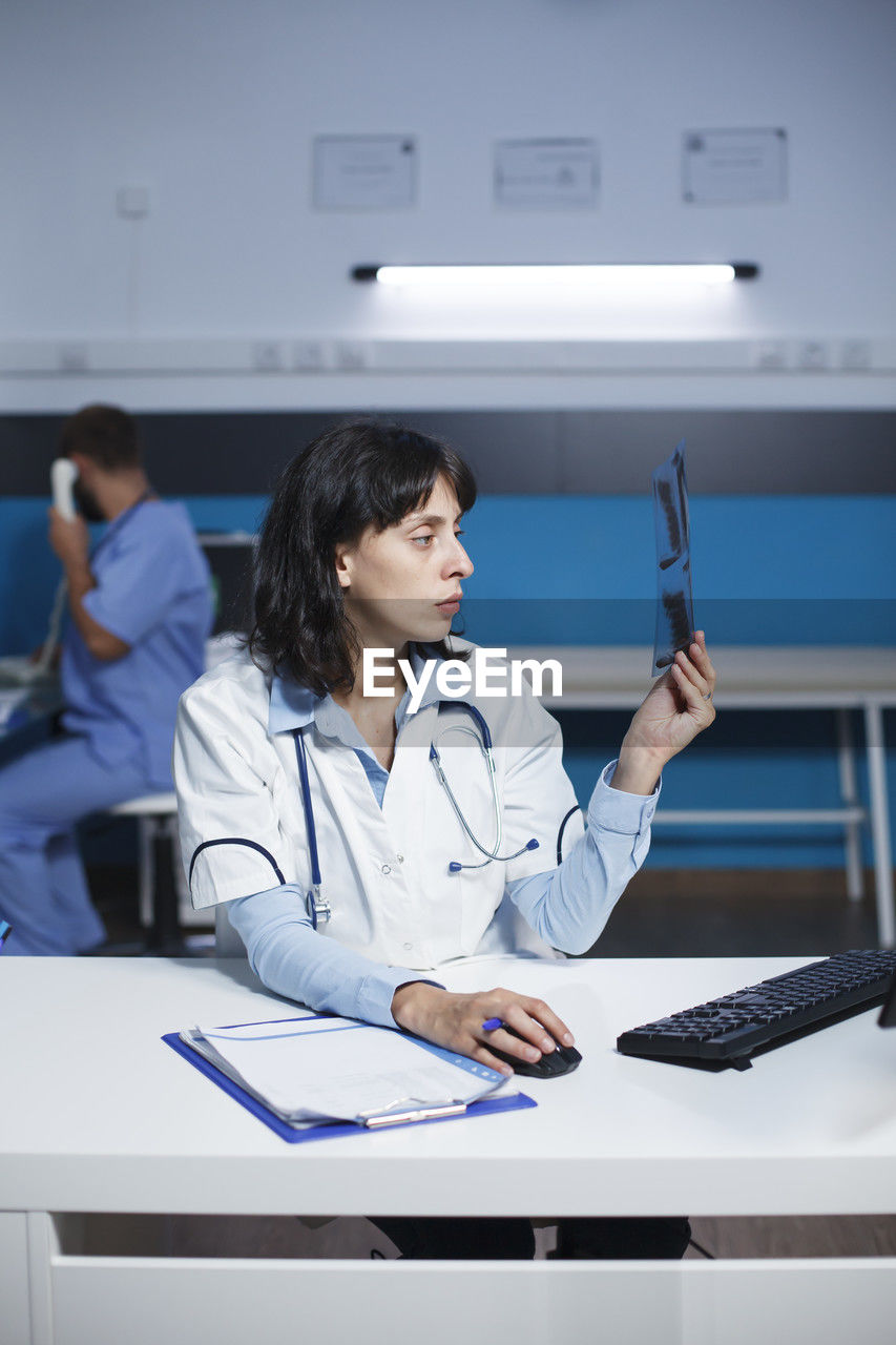 portrait of doctor examining patient in office