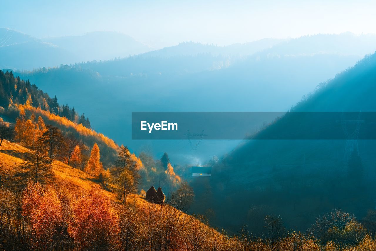 Panoramic view of landscape and mountains against sky in an autumn morning