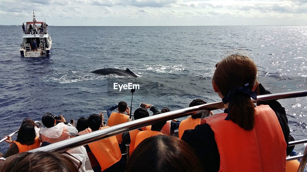 PEOPLE ON BOAT AGAINST SEA