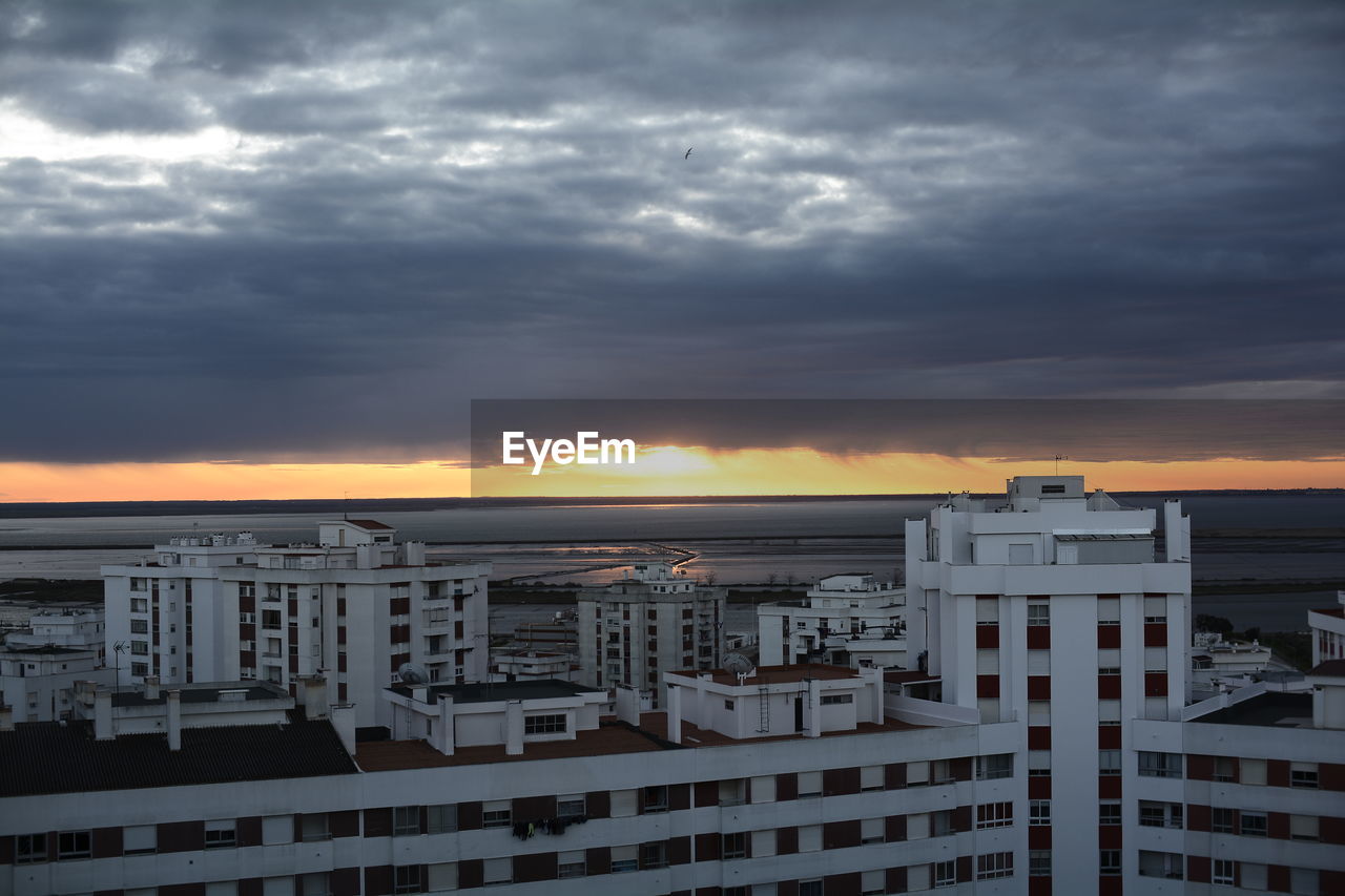 High angle view of buildings against dramatic sky