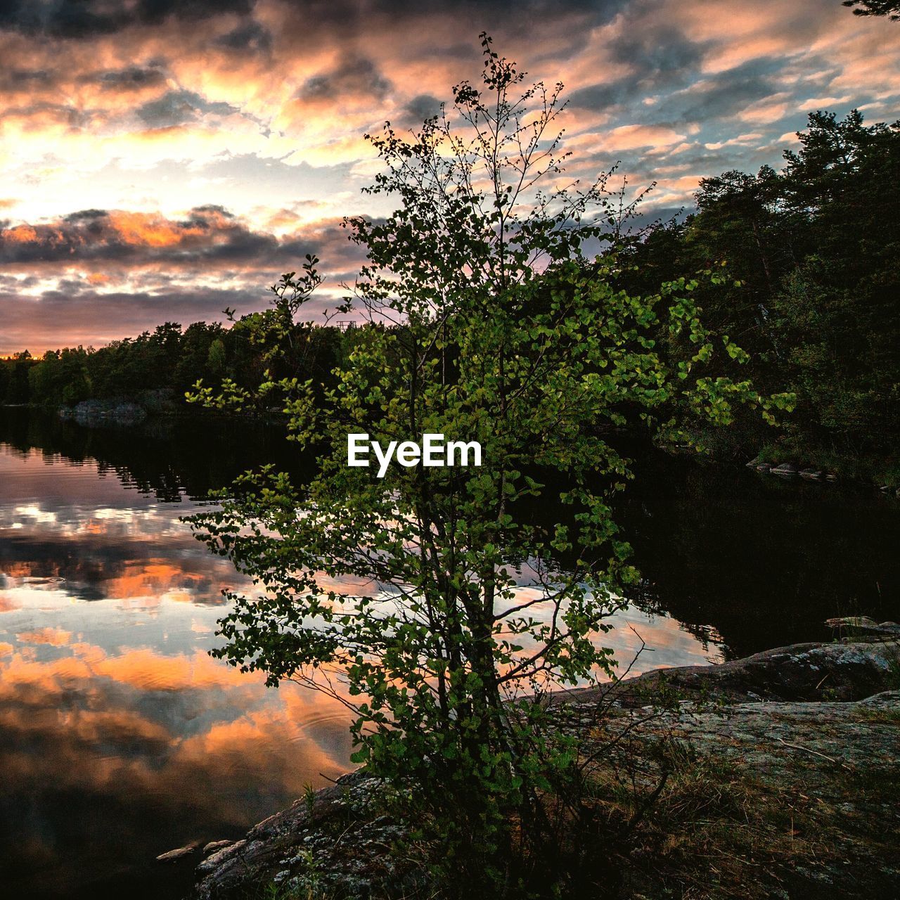 Scenic view of lake against cloudy sky