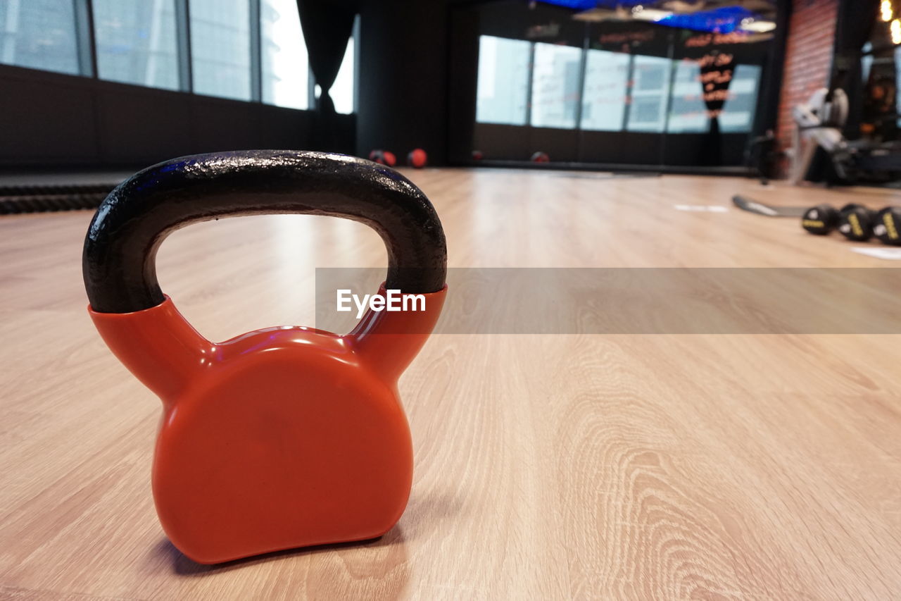 Red kettle bell on the gym floor