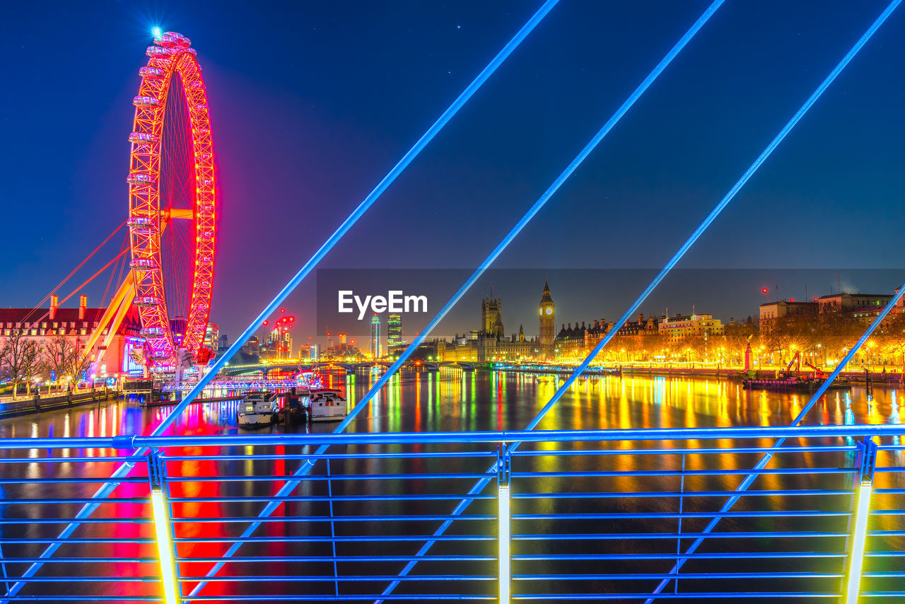 Illuminated suspension bridge in city at night