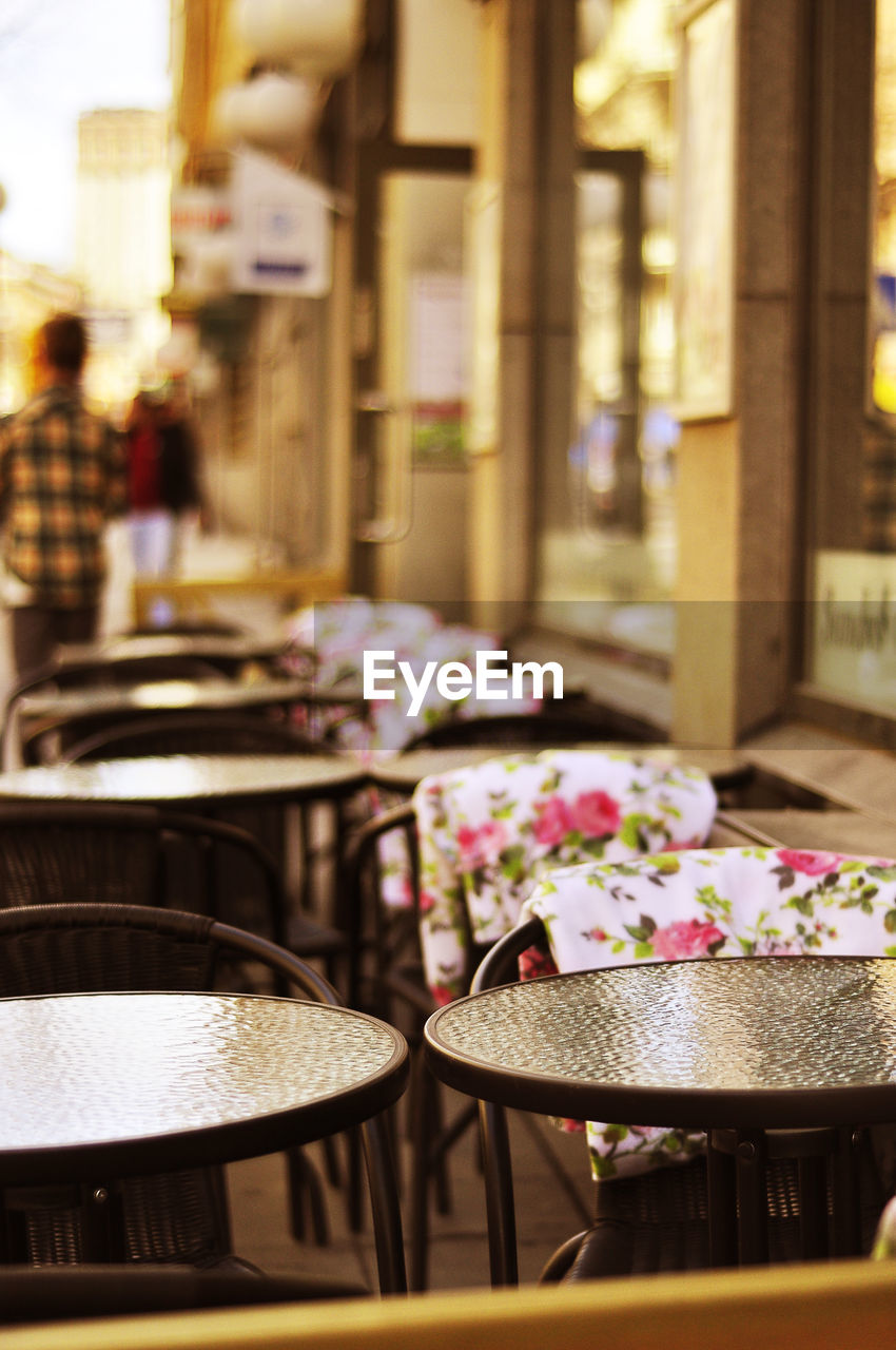 Commercial signs in store windows. romantic outdoor restaurant. holiday tourists in the background.