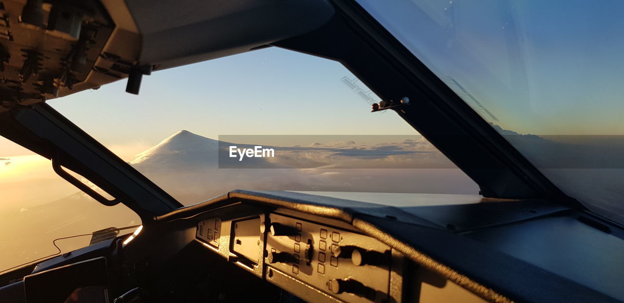 Airplane flying in sky during sunset