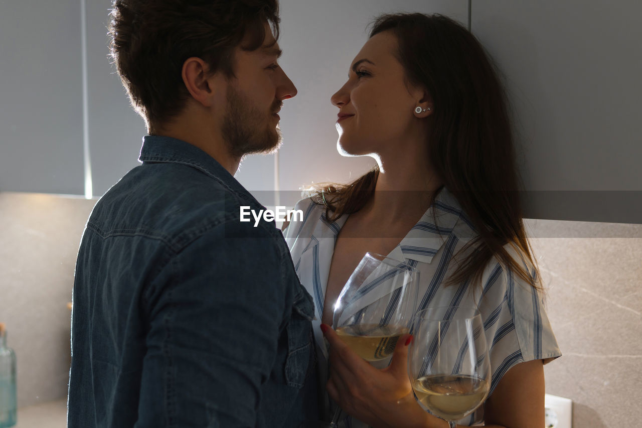 side view of young woman looking at girlfriend