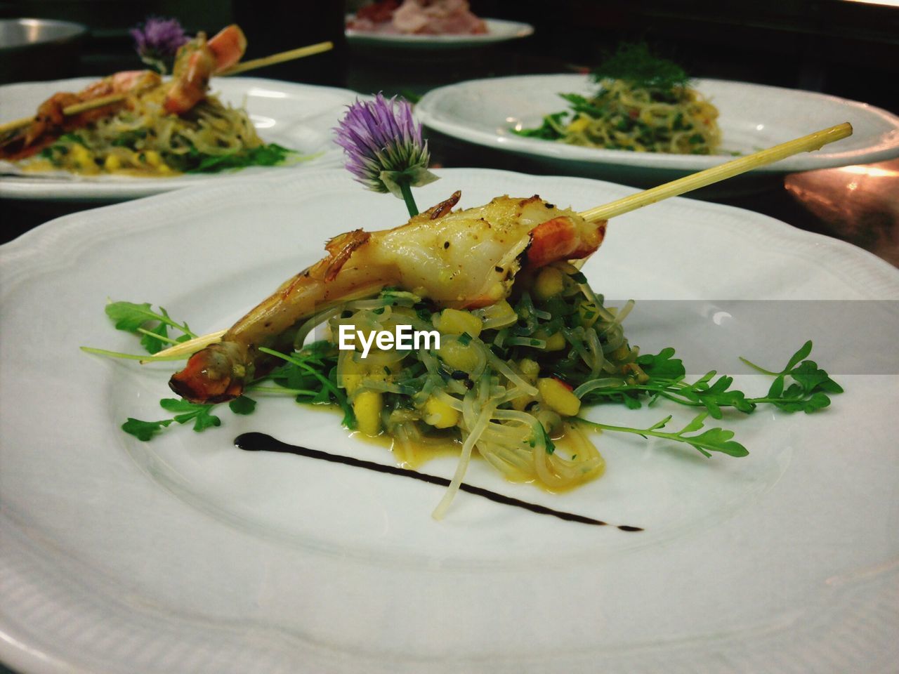 High angle view of shrimp with cellophane noodles and mango in plate