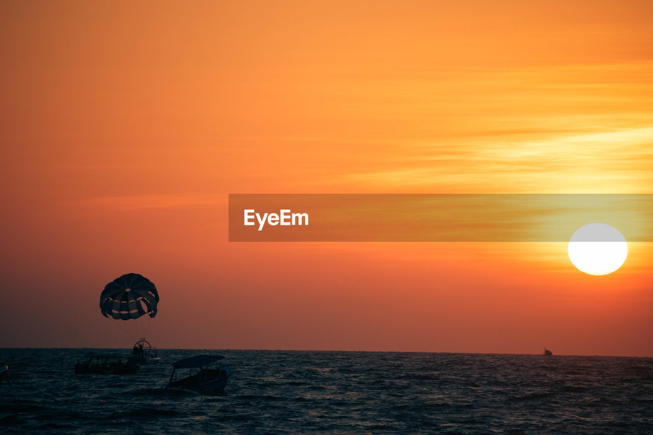 scenic view of sea against orange sky during sunset