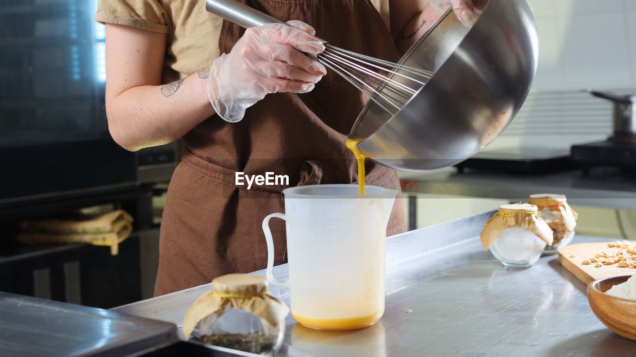 midsection of woman preparing food in kitchen