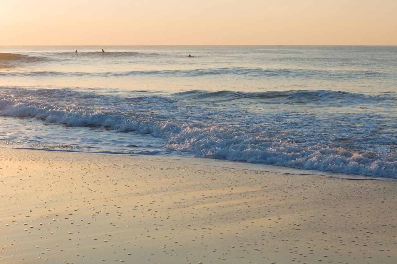 Scenic view of beach against sky during sunset