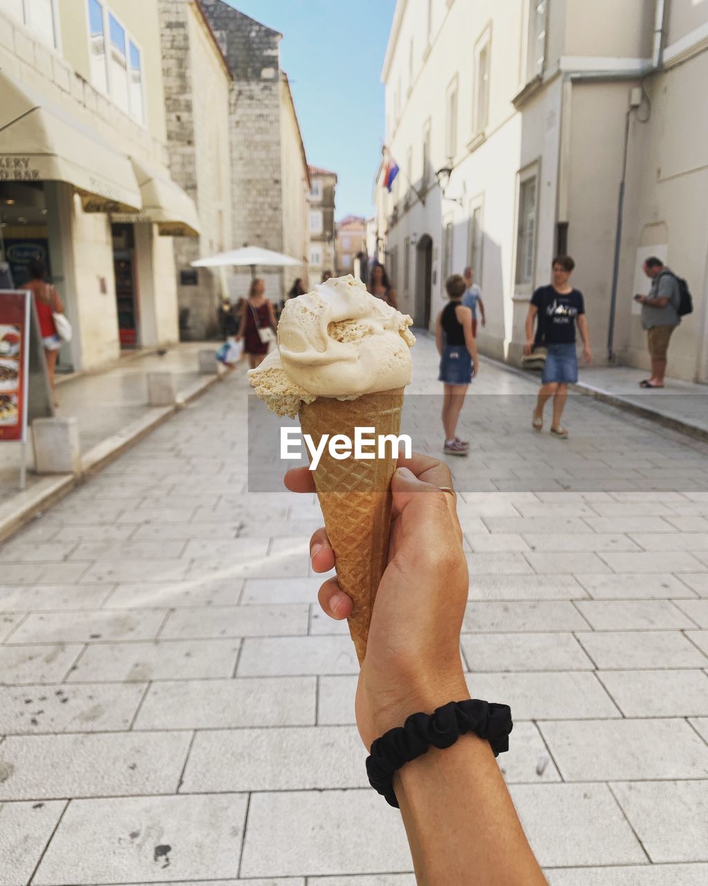 WOMAN HOLDING ICE CREAM CONE