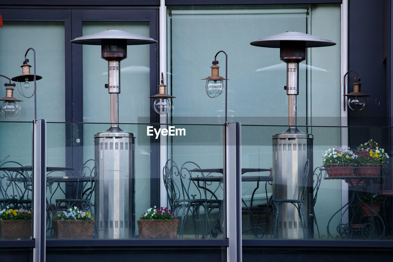 POTTED PLANTS ON STREET LIGHT AGAINST BUILDING