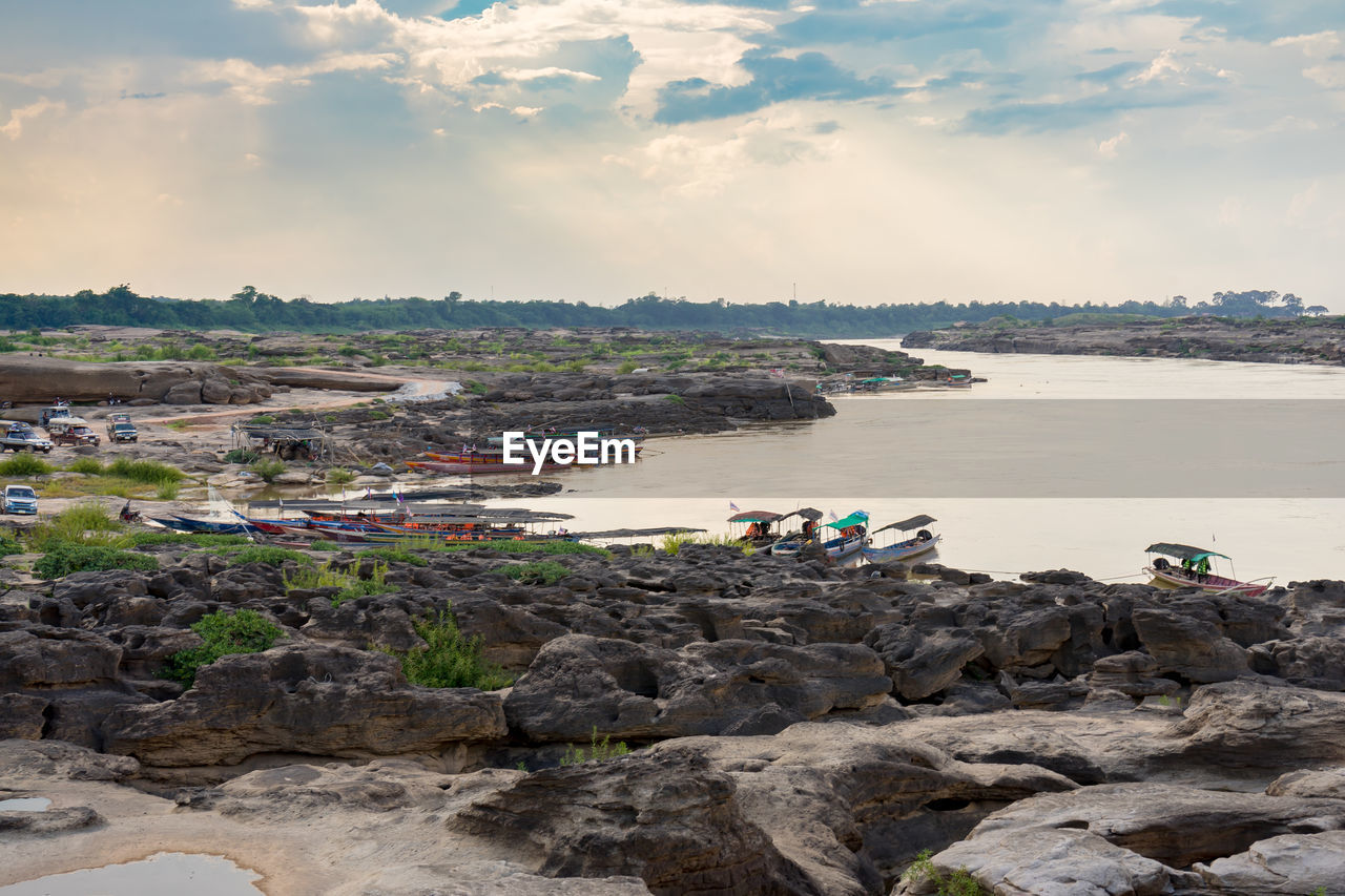 SCENIC VIEW OF ROCKS ON BEACH AGAINST SKY