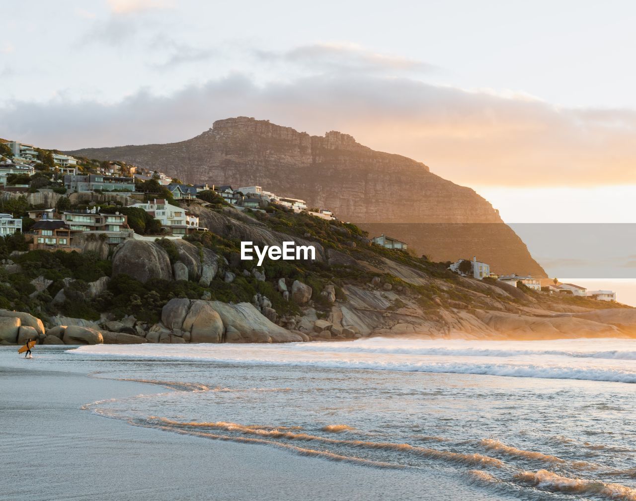 Scenic view of sea and mountains against sky