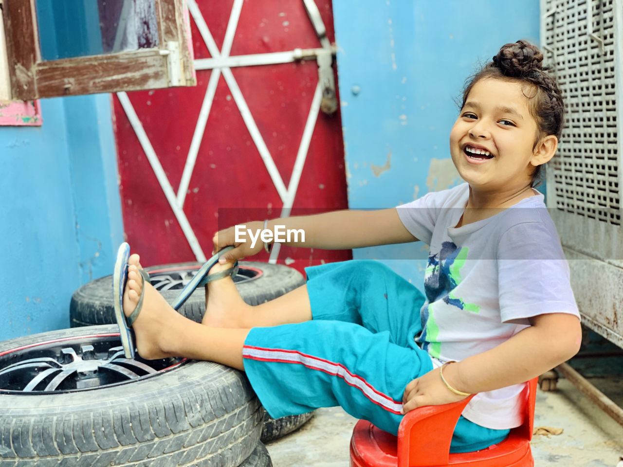 Portrait of smiling boy sitting outdoors