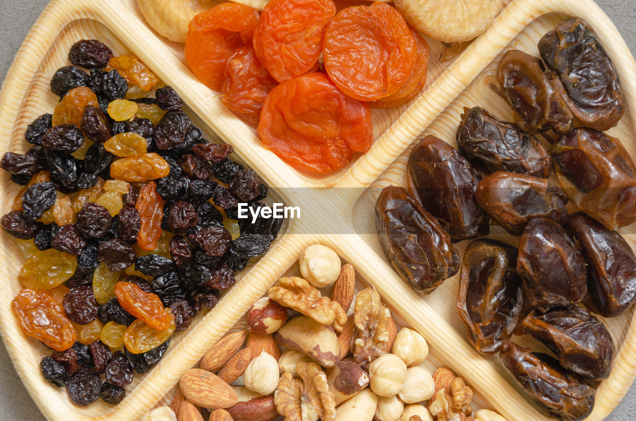 Combined plate with dried fruits and nuts. in each compartment of the plate there is food