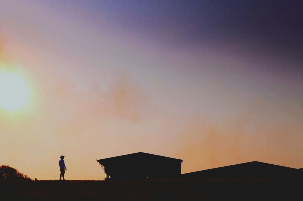 LOW ANGLE VIEW OF SILHOUETTE BUILT STRUCTURE AGAINST SKY AT SUNSET