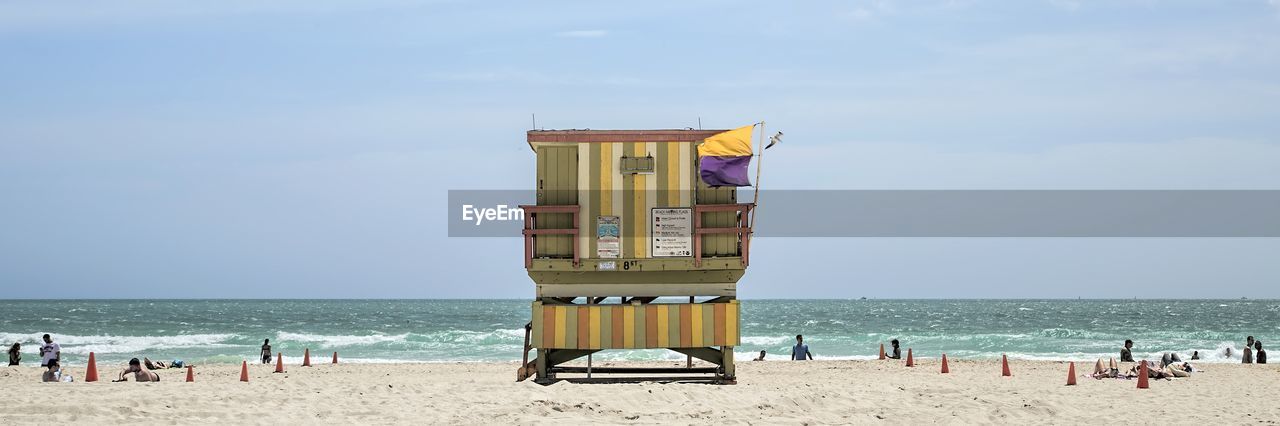 Lifeguard hut on beach against sky