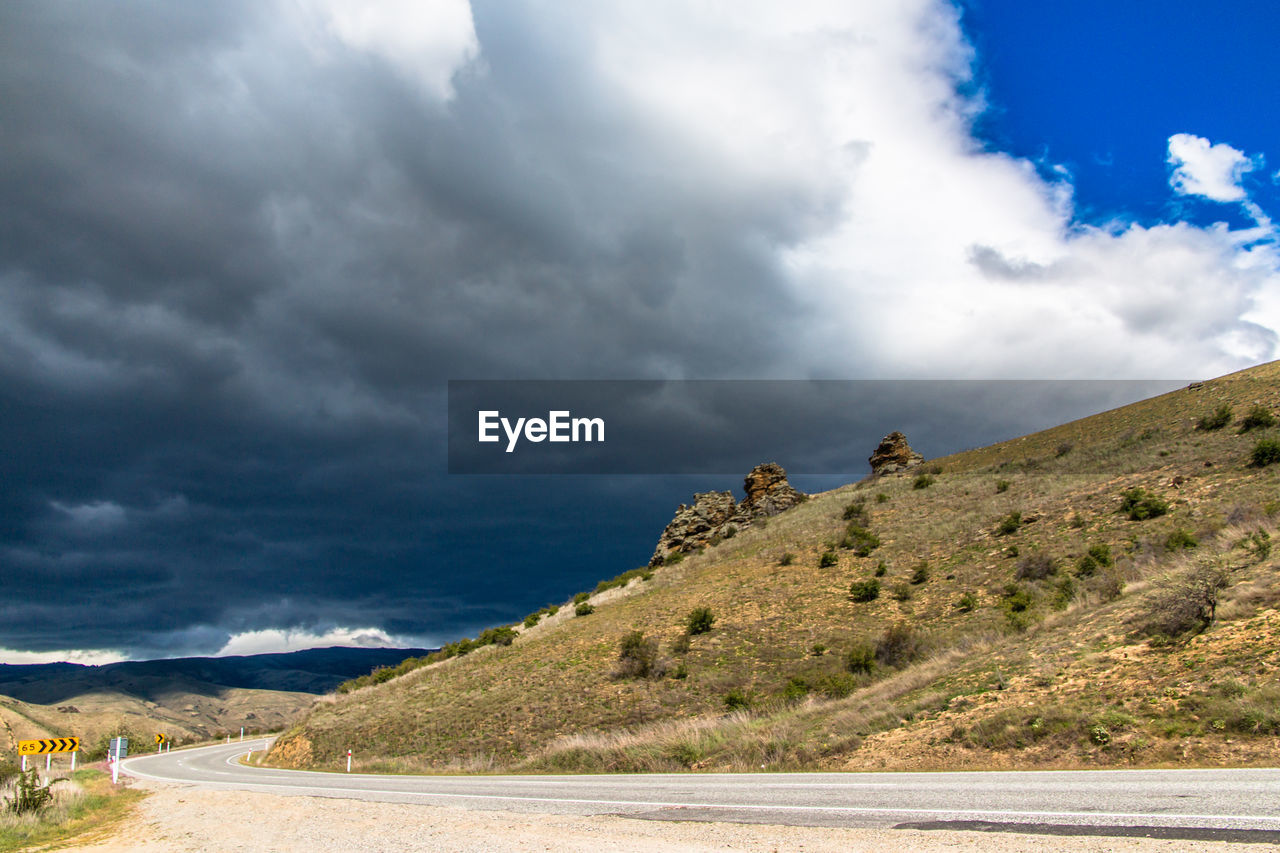 Scenic view of mountain against cloudy sky