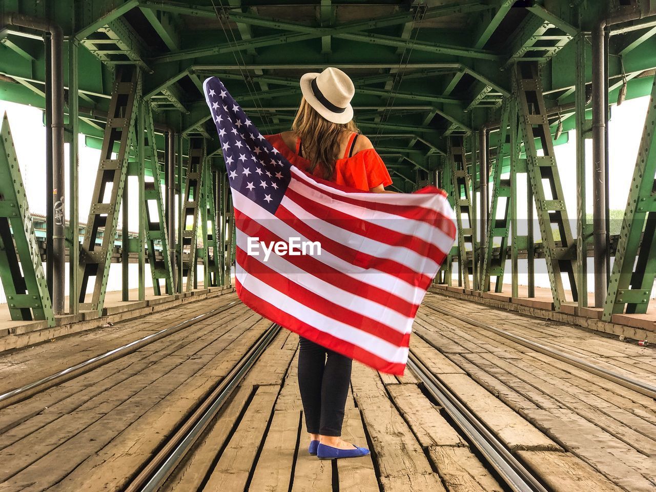 Rear view of woman holding american flag 