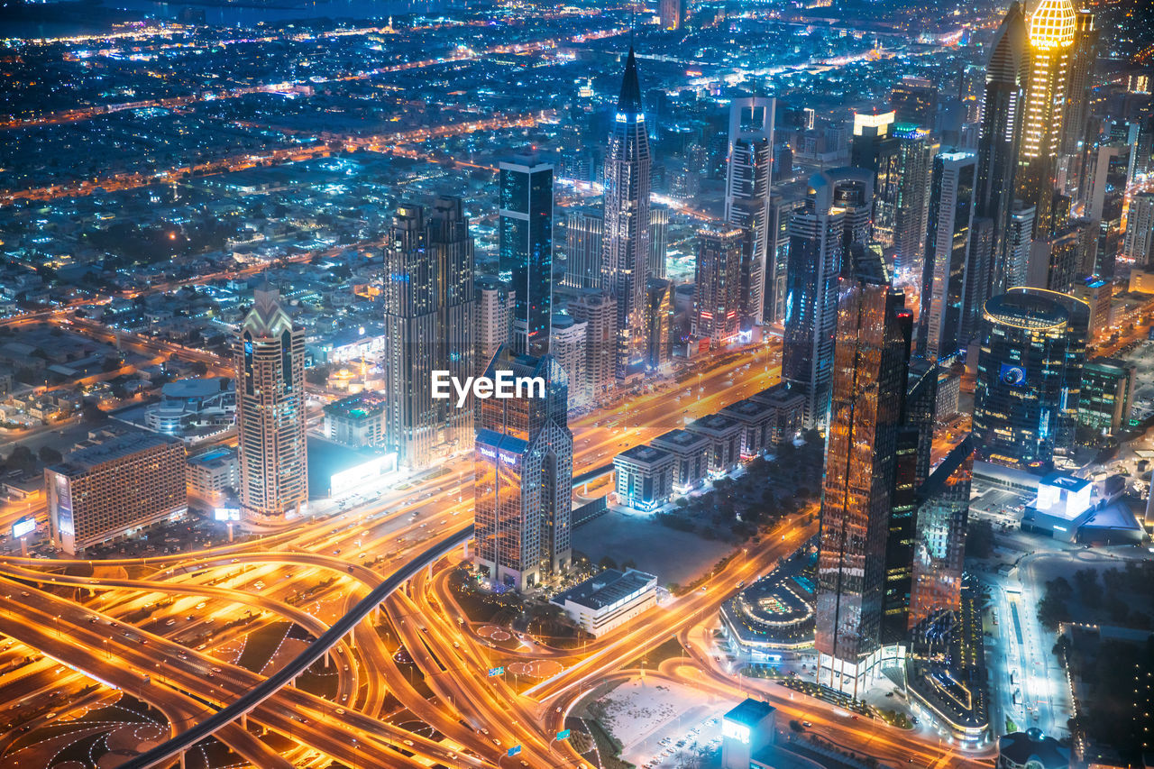 high angle view of illuminated cityscape against sky at night