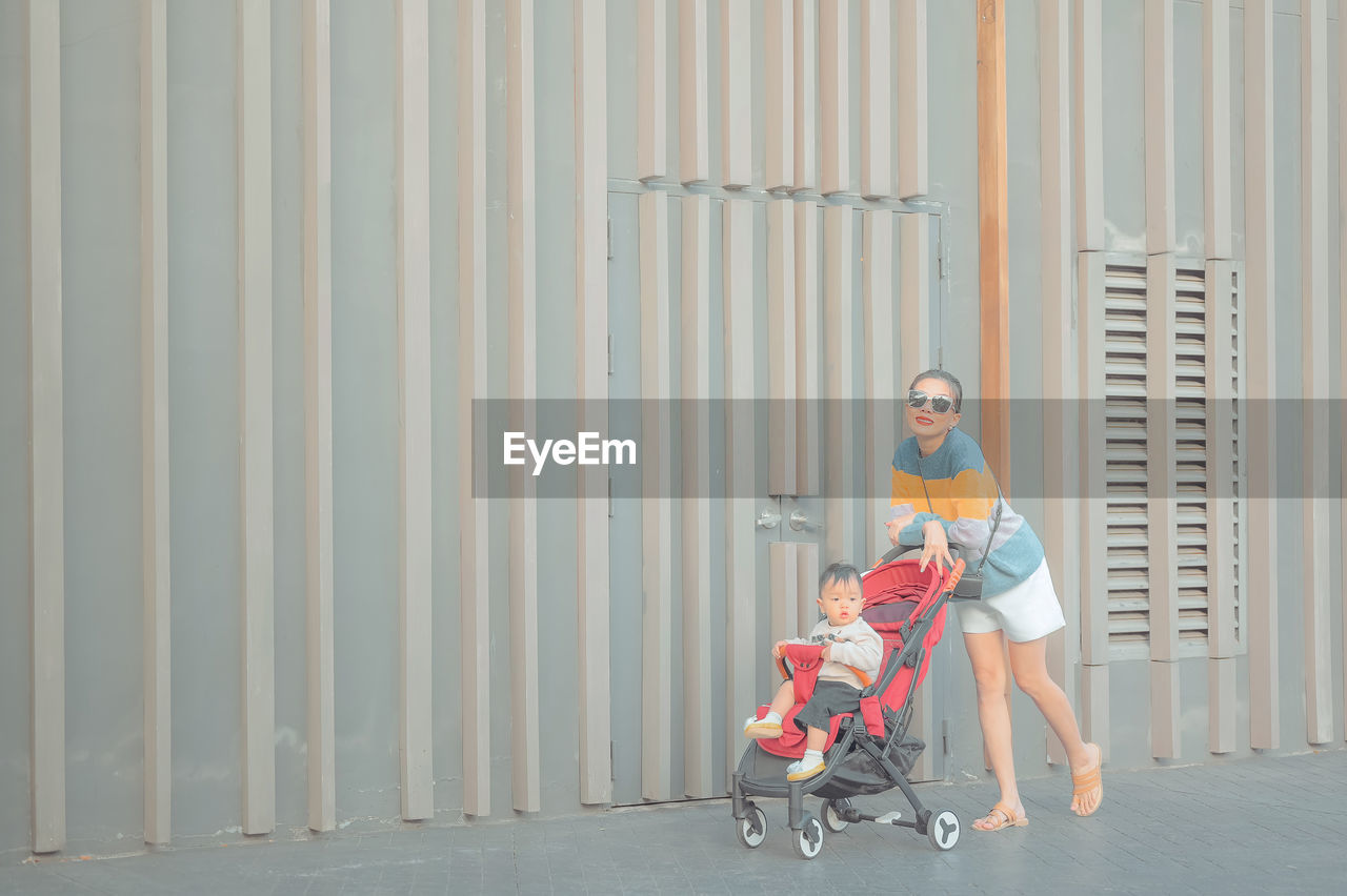 Portrait of mother with son in carriage