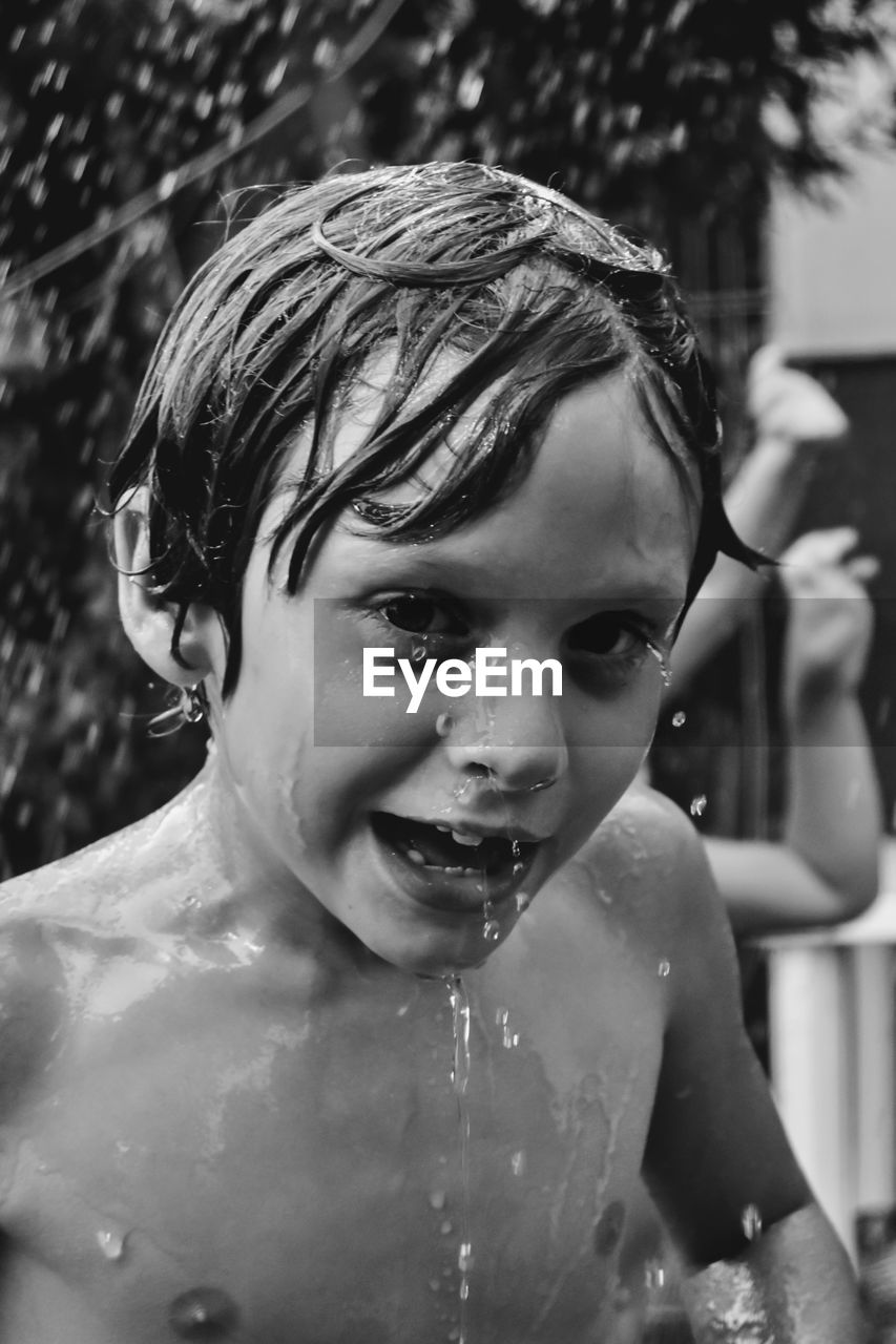 Portrait of shirtless boy in bathroom