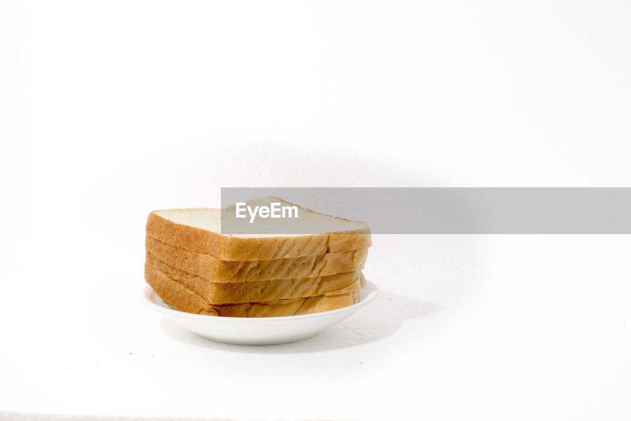 Close-up of breads against white background