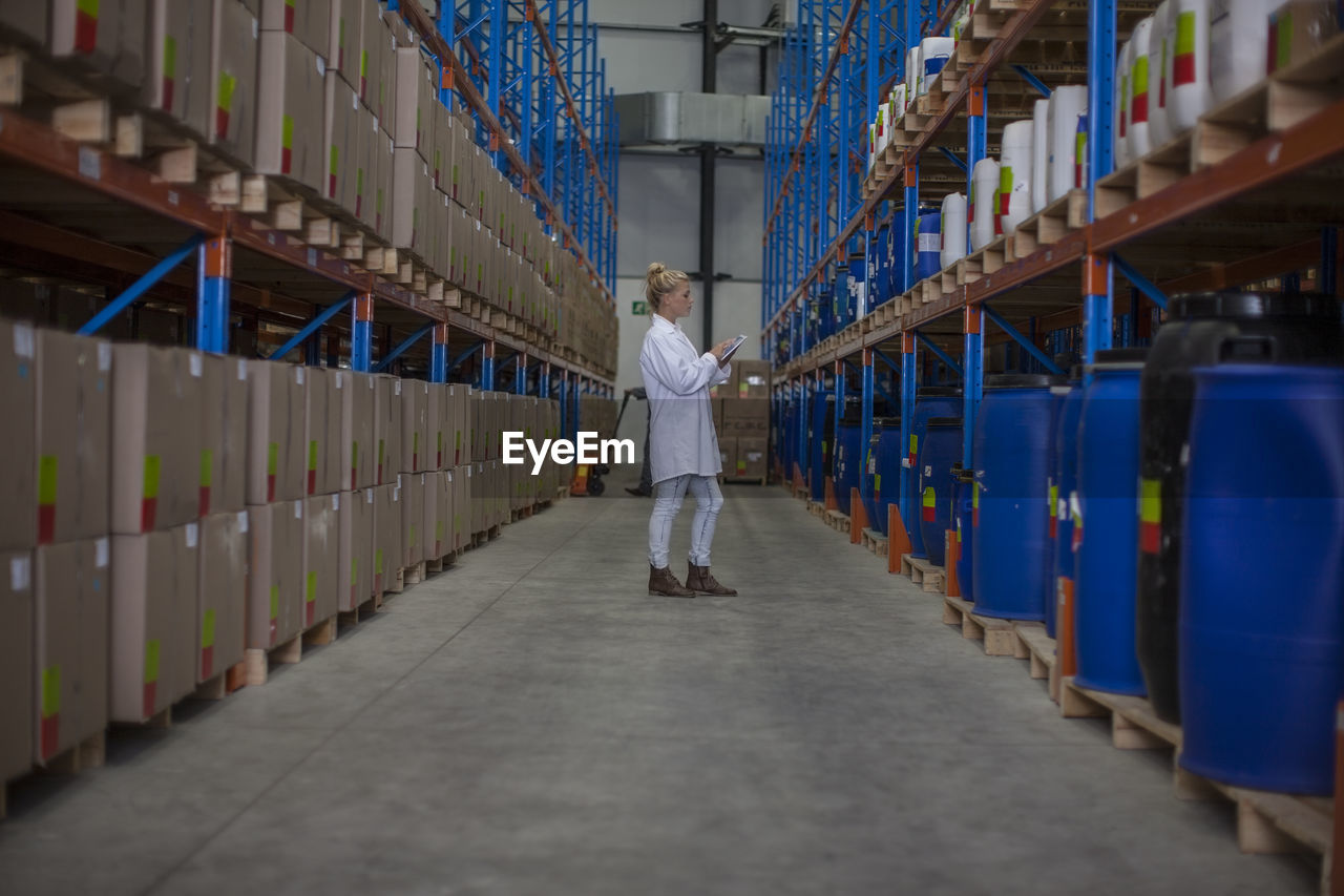 Woman with digital tablet in warehouse