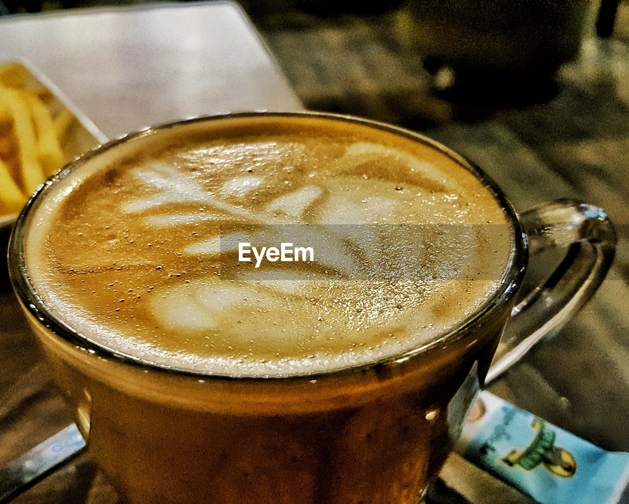 CLOSE-UP OF COFFEE CUP ON TABLE