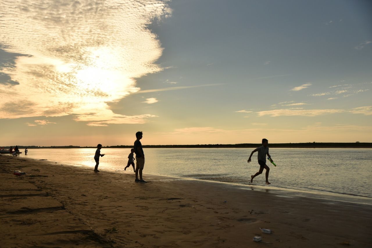 SILHOUETTE OF GIRL WALKING ON BEACH