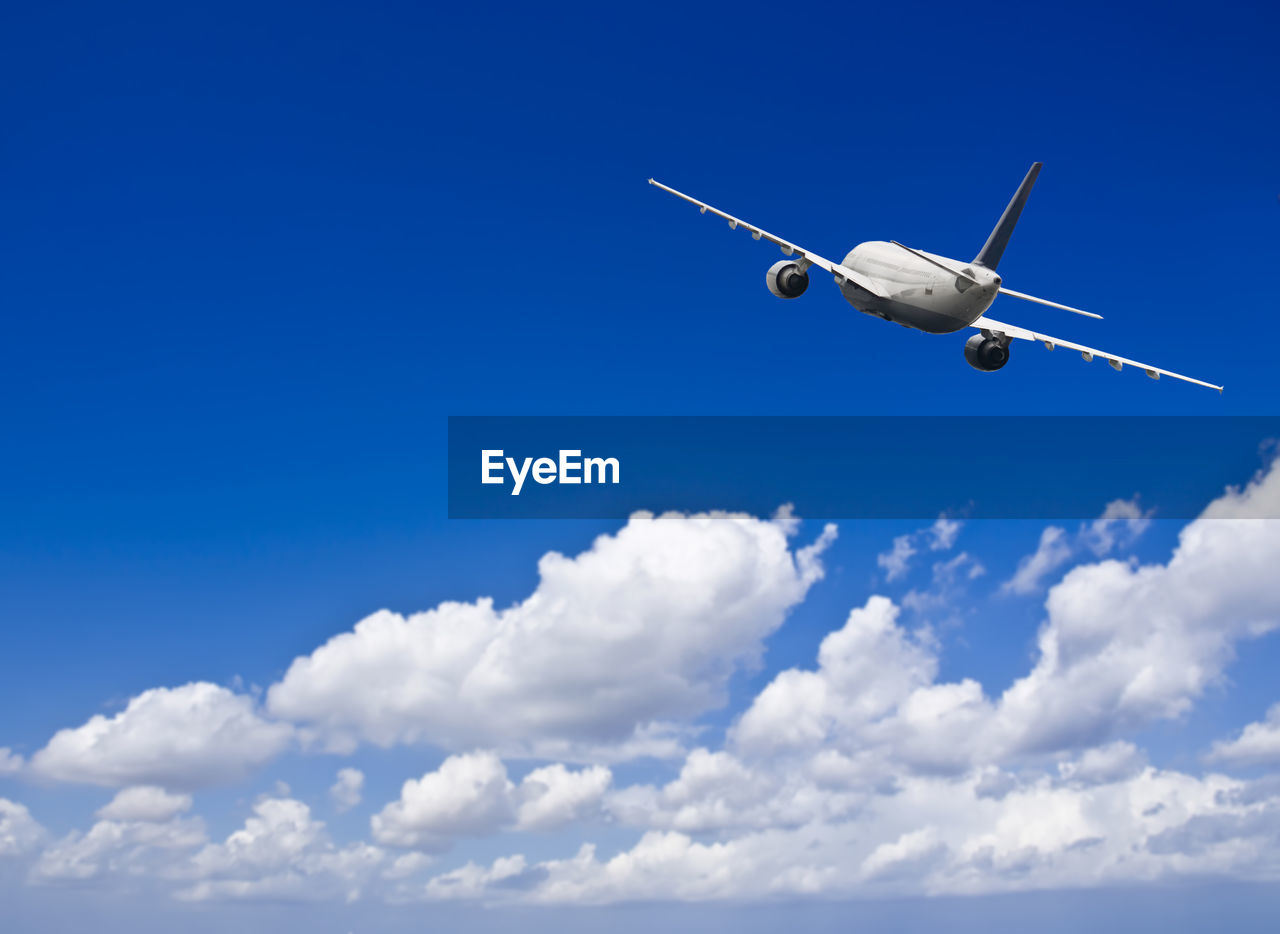 Civil jet airliner in a blue sky with some clouds