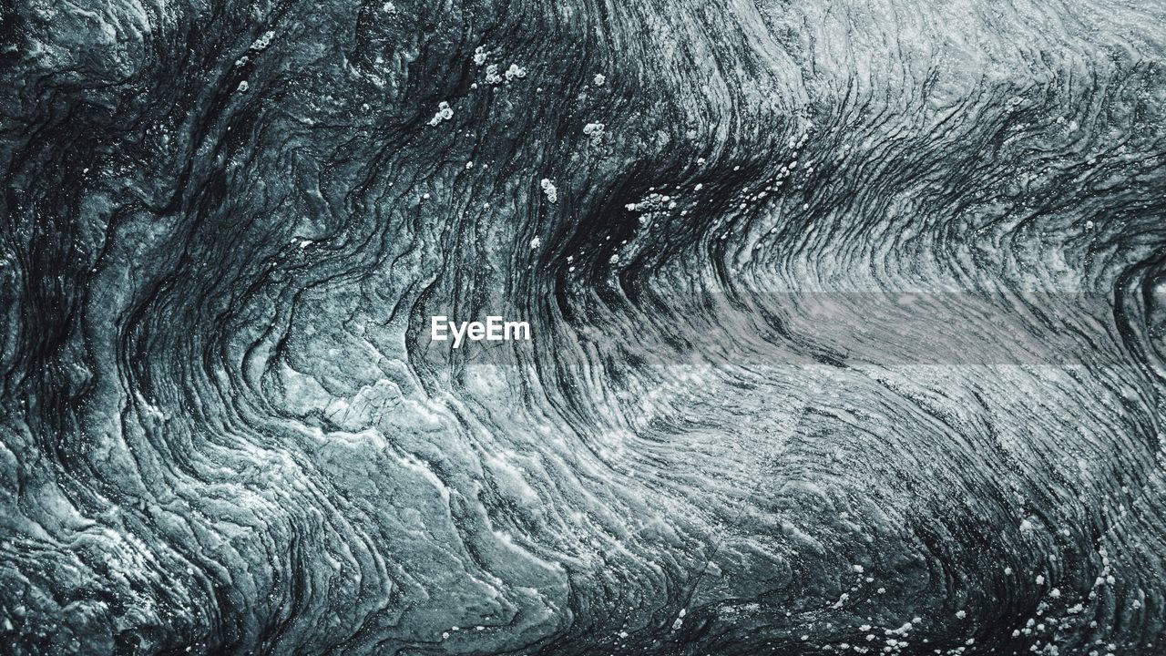 Full frame shot of abstract wave pattern rock
