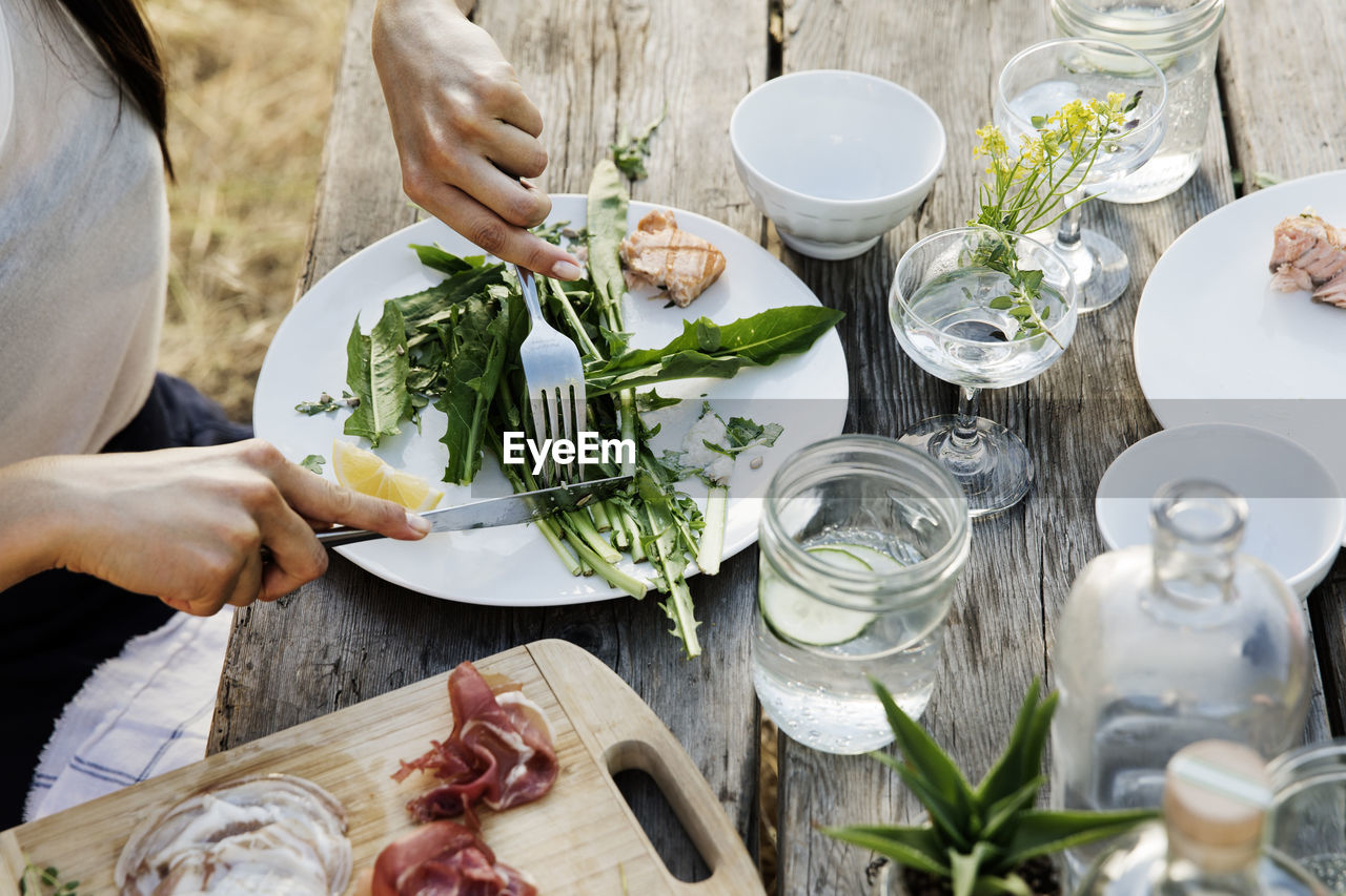 High angle view of woman having salad at table