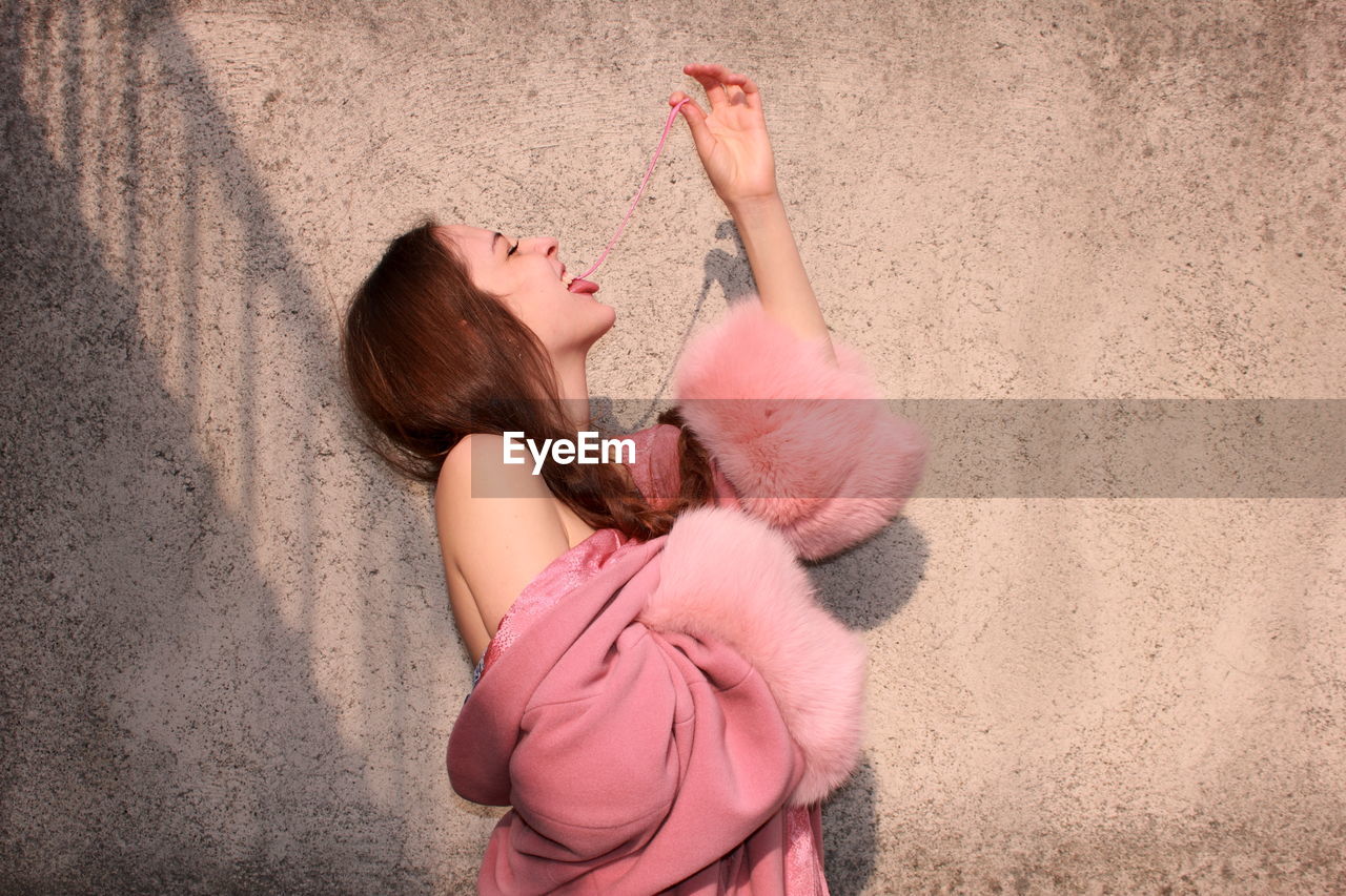 Young woman eating chewing gum