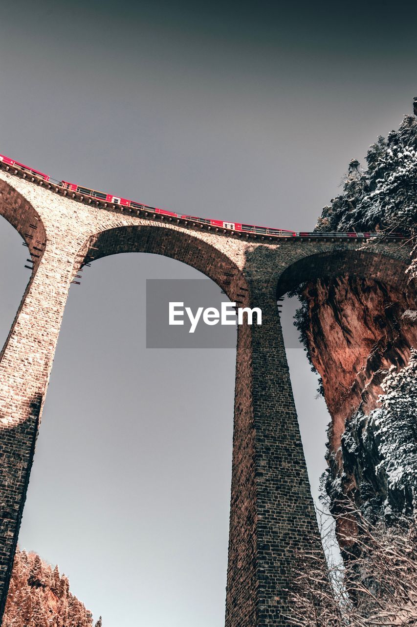 Low angle view of train on railway bridge