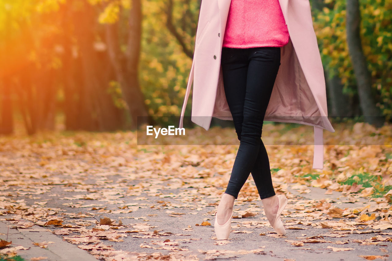 low section of woman walking on field