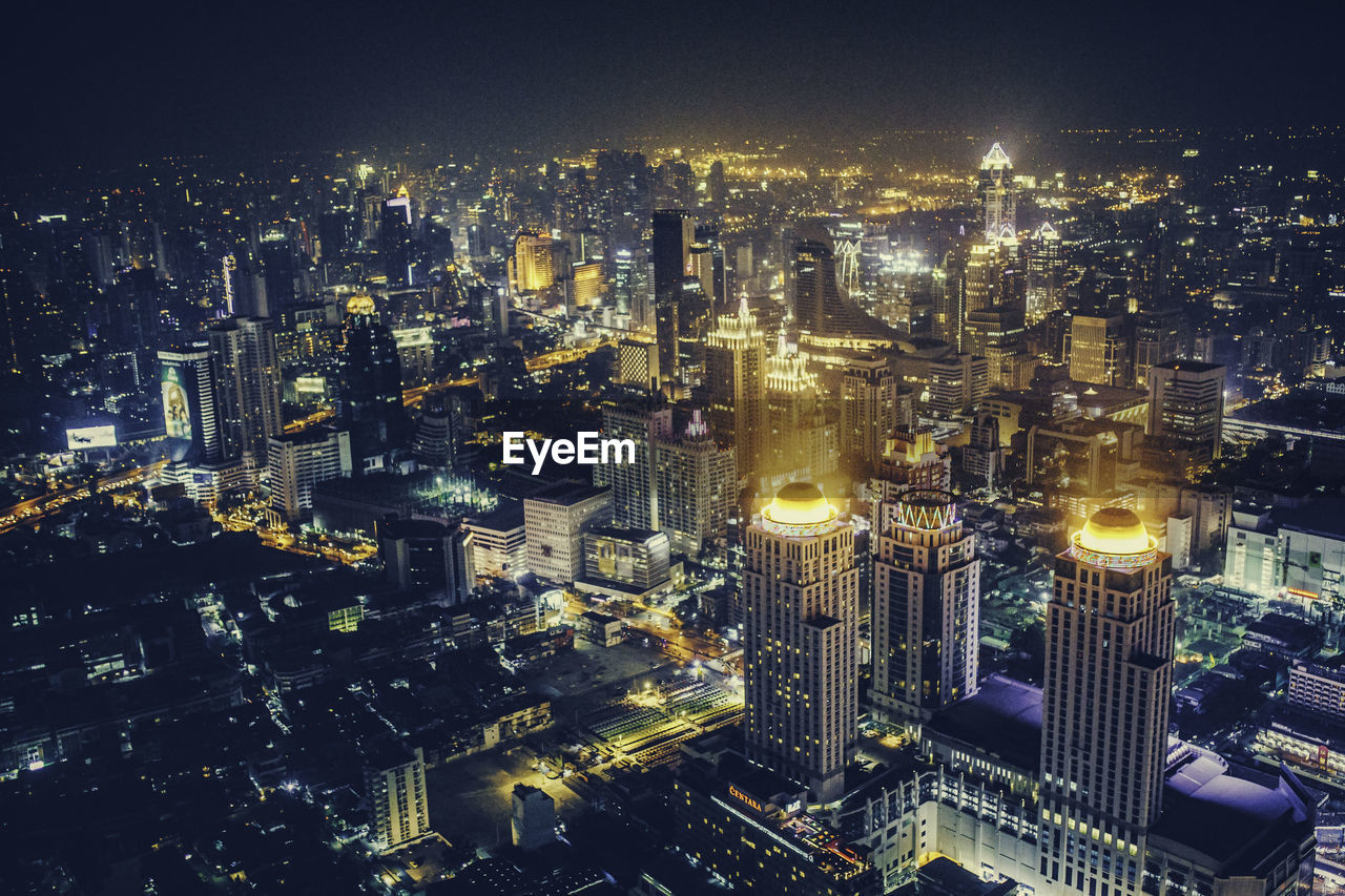 High angle view of illuminated city buildings at night