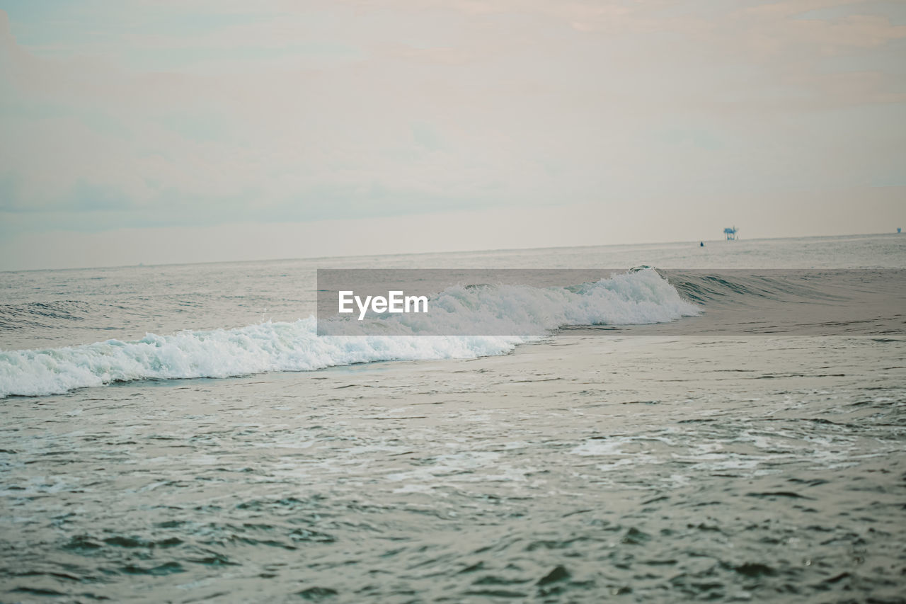 SCENIC VIEW OF WAVES RUSHING TOWARDS SHORE