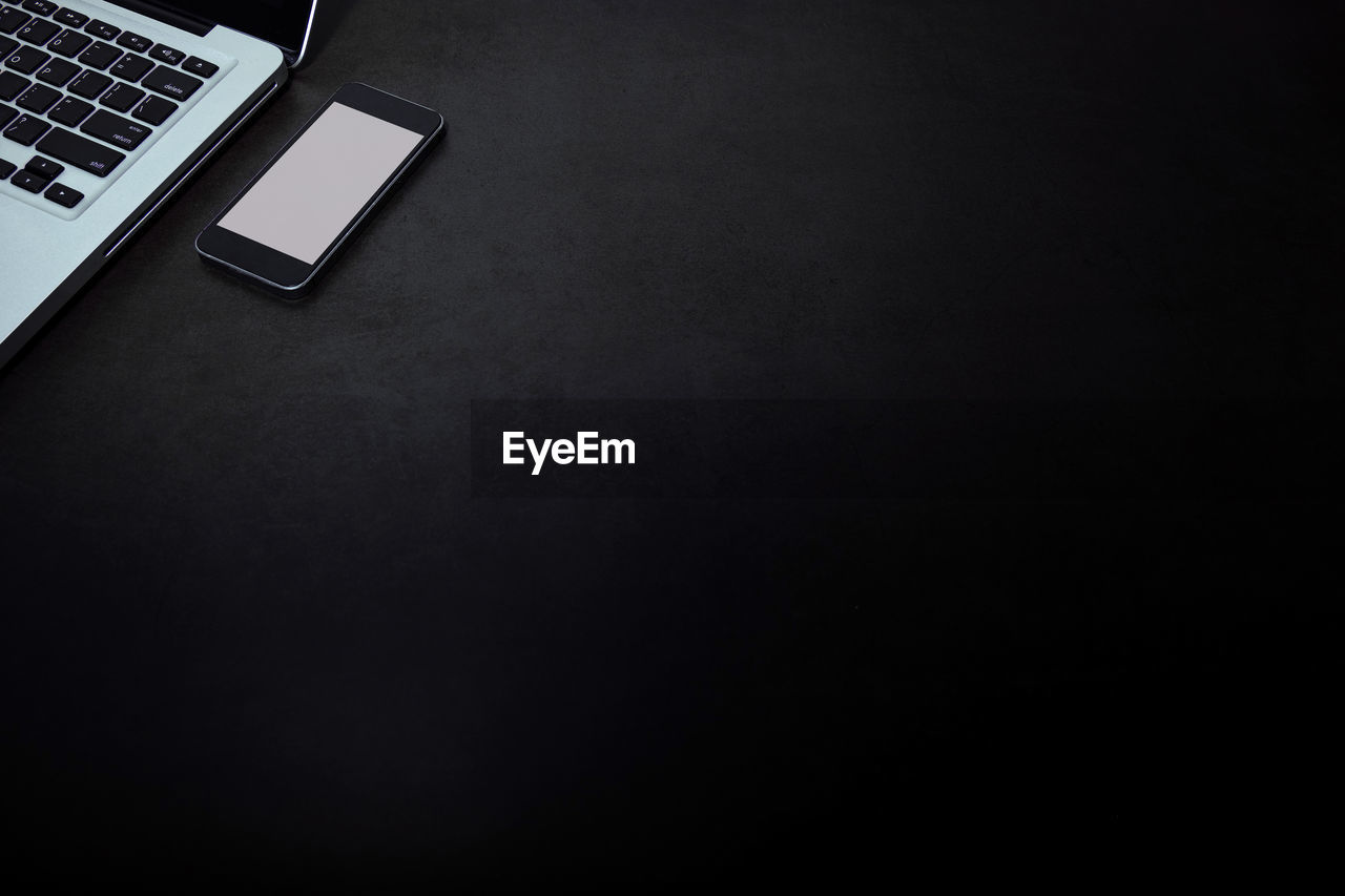 High angle view of laptop and smart phone on table