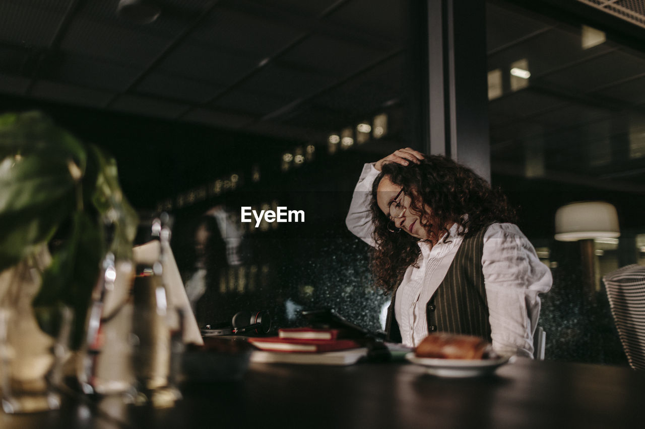 Woman in office at night