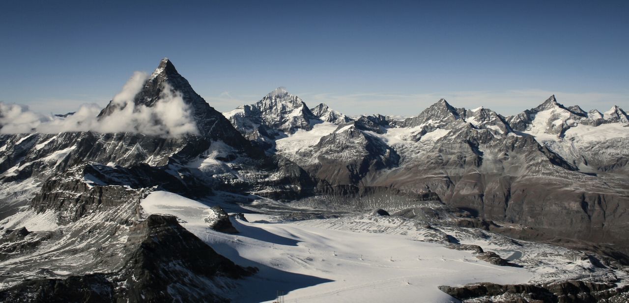 Scenic view of snowy mountains against clear sky