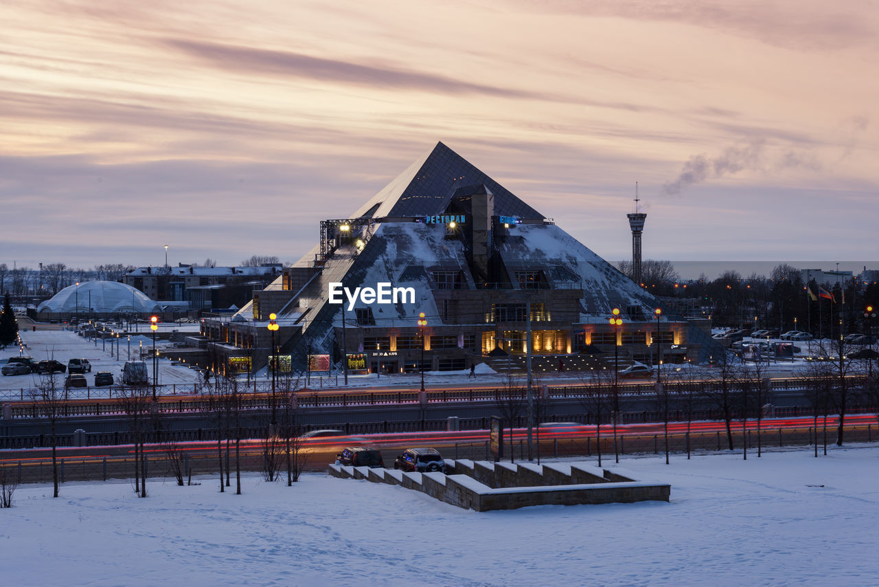 SNOW COVERED BUILDINGS AGAINST SKY DURING WINTER