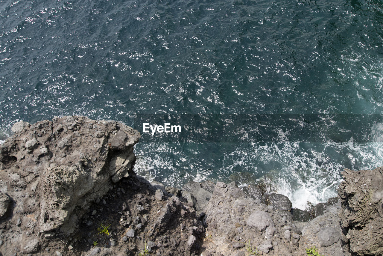 High angle view of rocks in sea