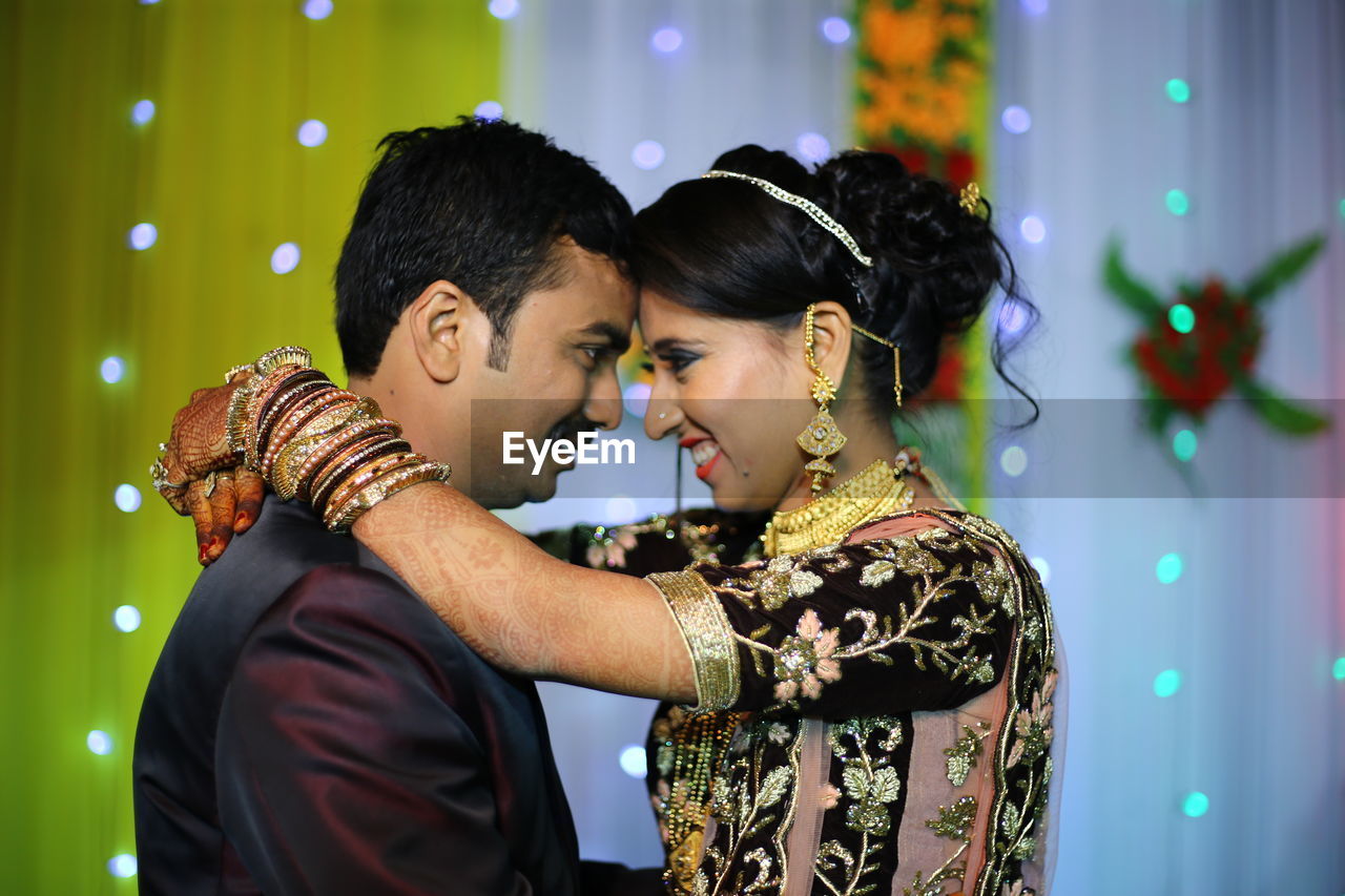 Side view of young couple during wedding ceremony