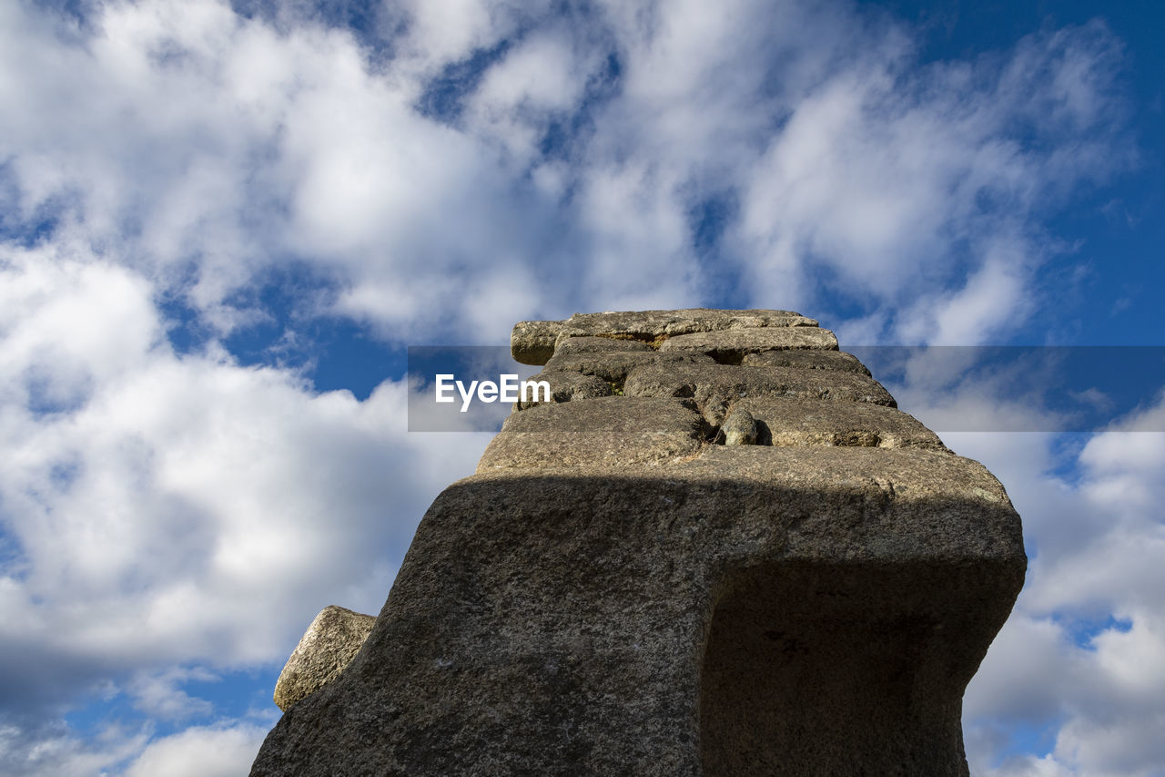 Low angle view of old ruin building against cloudy sky